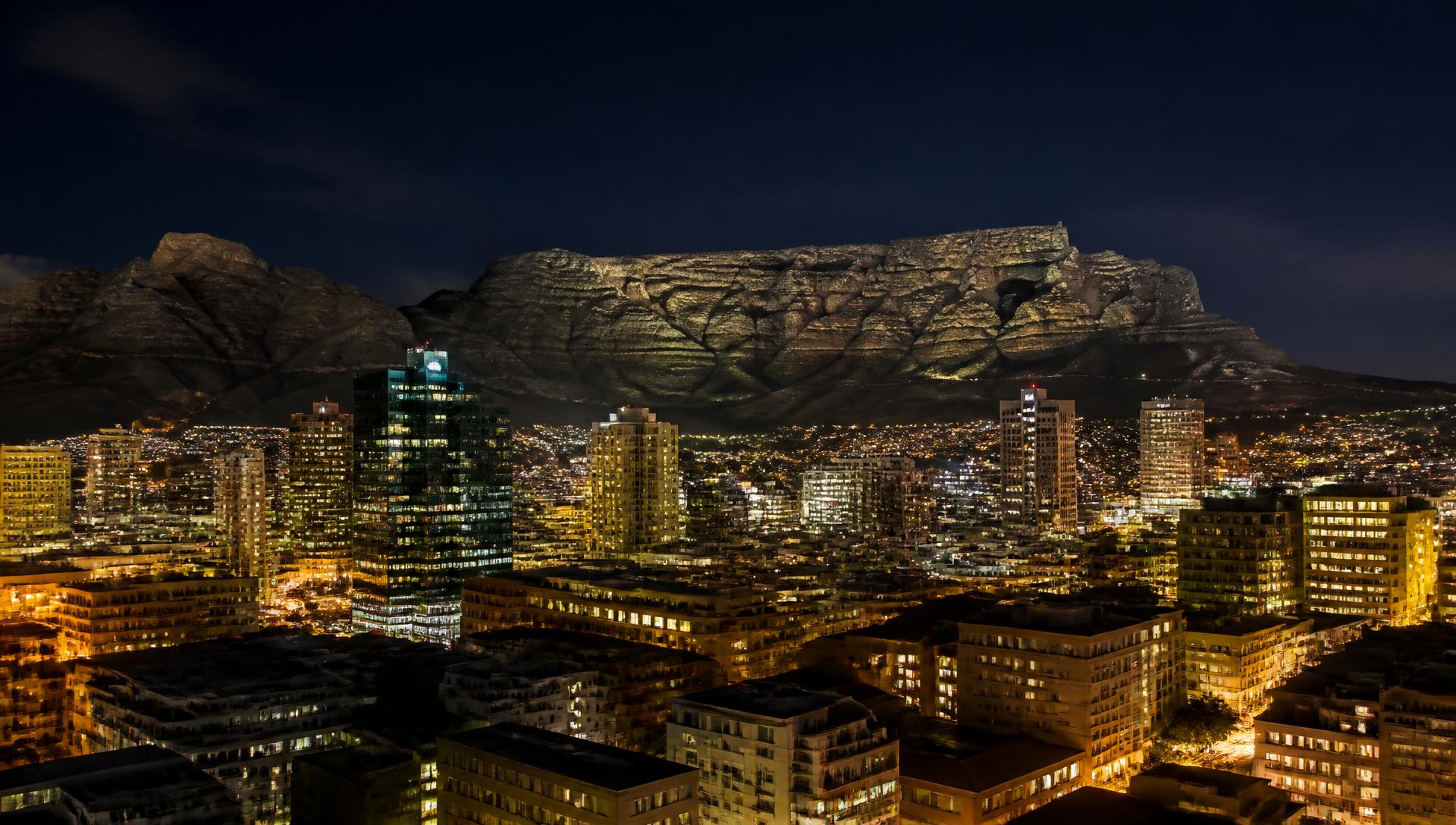 Cape Town city lights beneath Table Mountain at night
